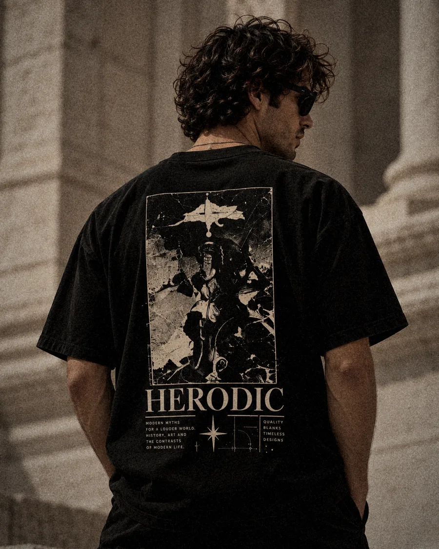 Model from behind in The Relic washed black tee, against classical stone columns