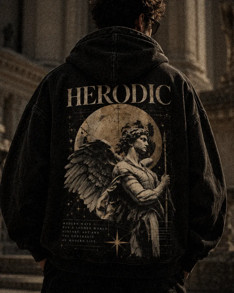 Model from behind in a washed black HERODIC hoodie with the winged statue and golden moon back print
