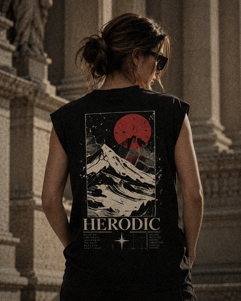 Model from behind in the Crimson Summit black boxy tank, red sun and mountain back print
